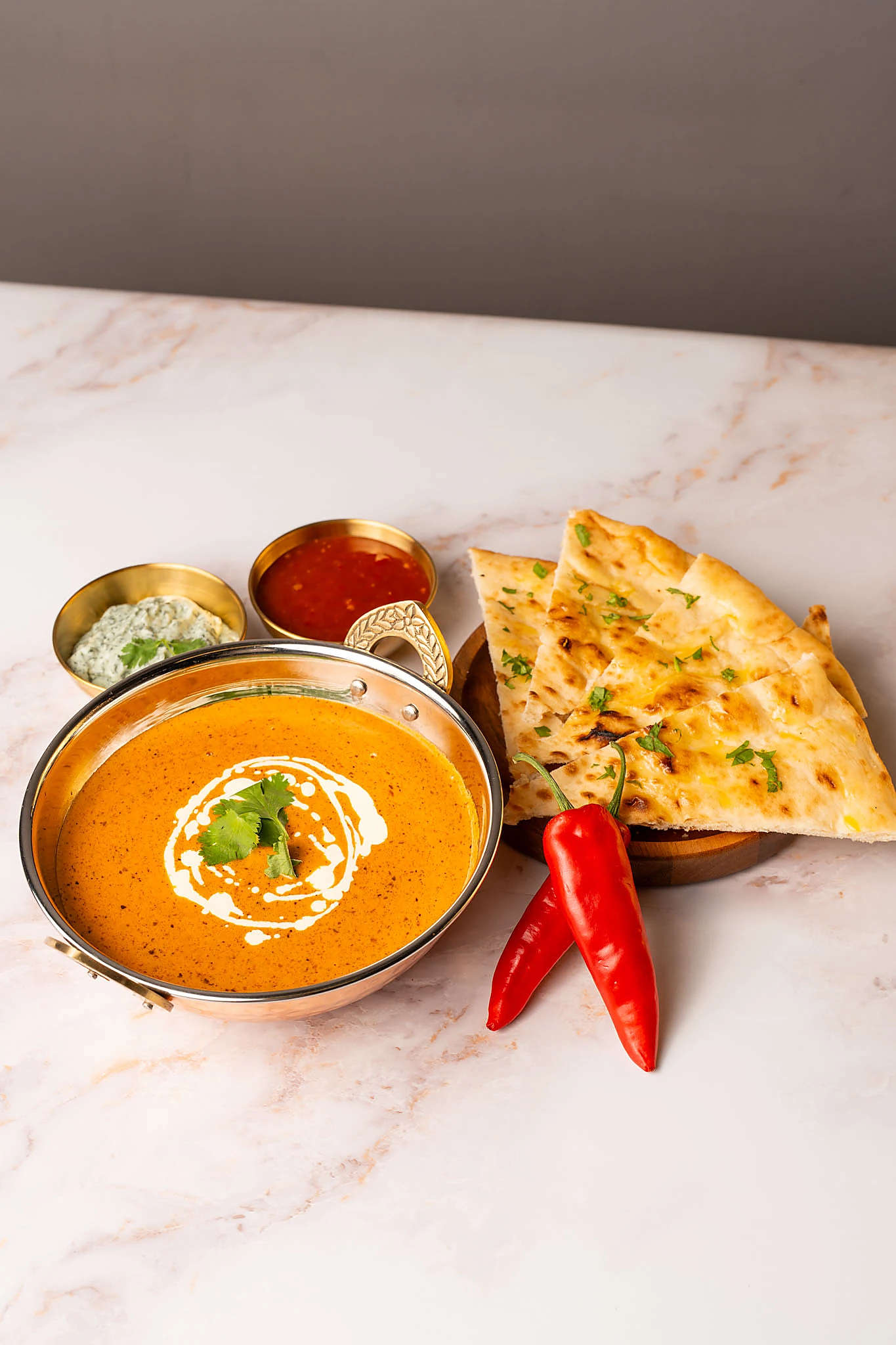 Rich butter chicken curry served with naan